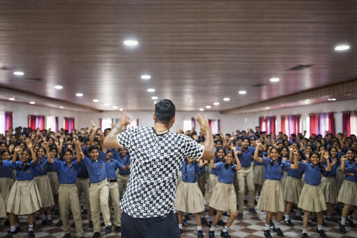 Jothi leading a session with hundreds of school students
